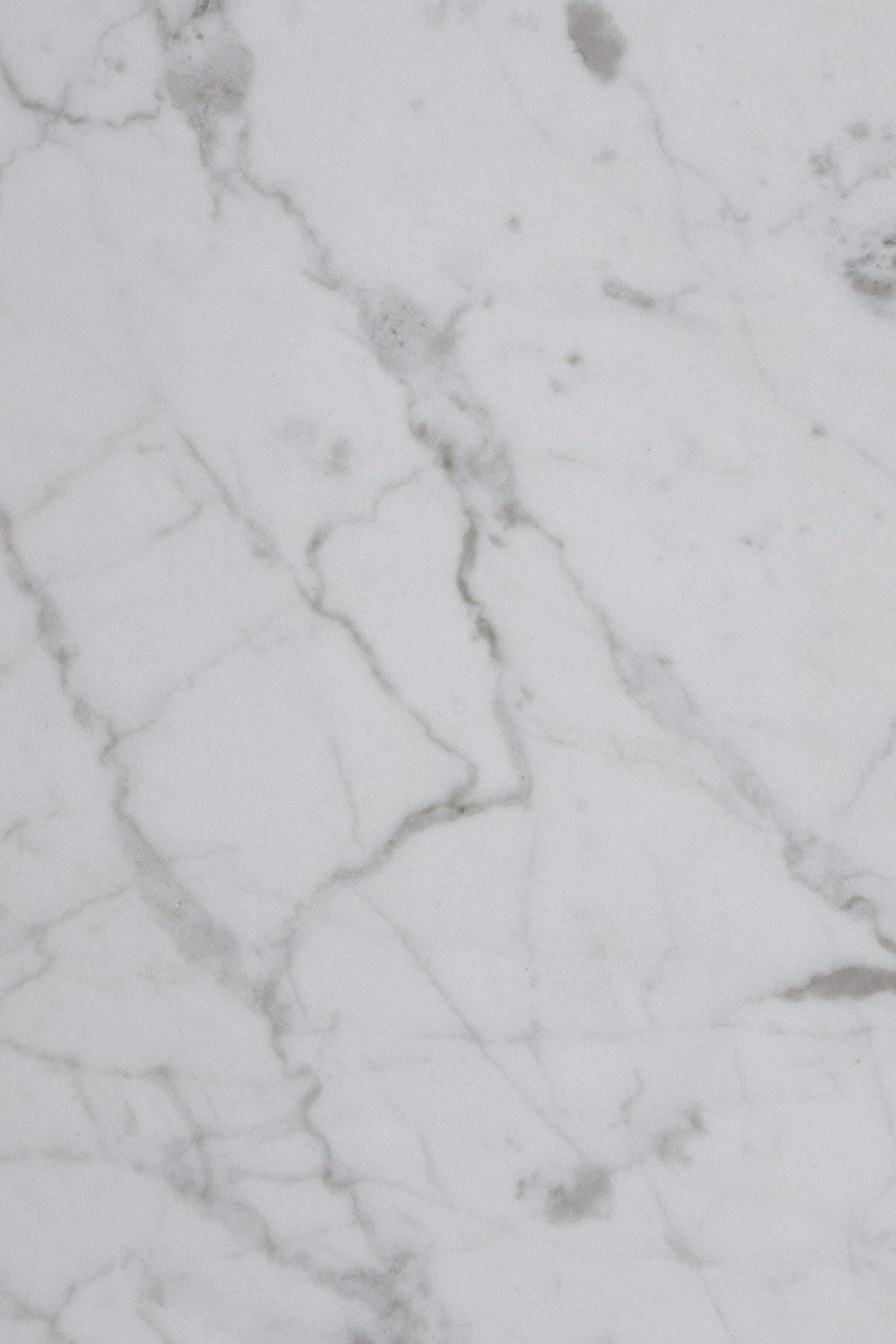 Close up of smooth white and grey veined marble, the material language of a Paris Palace spa