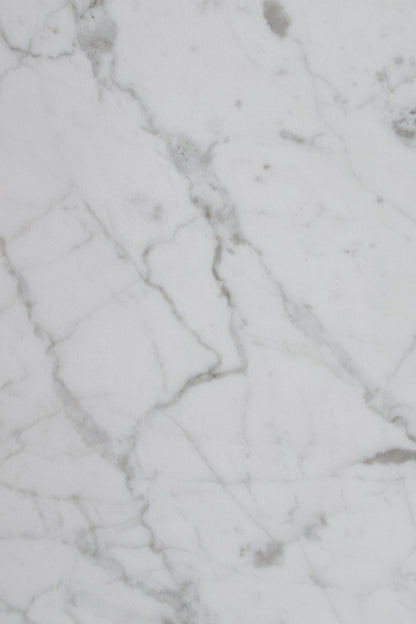 Close up of smooth white and grey veined marble, the material language of a Paris Palace spa