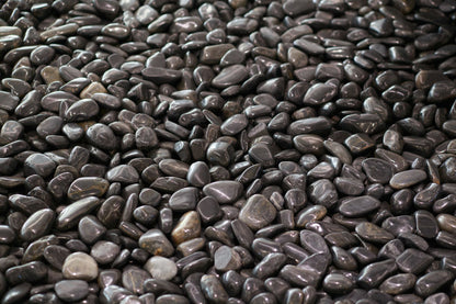 Smooth dark stones in close up, evoking the Lake District slate around Brimstone Spa