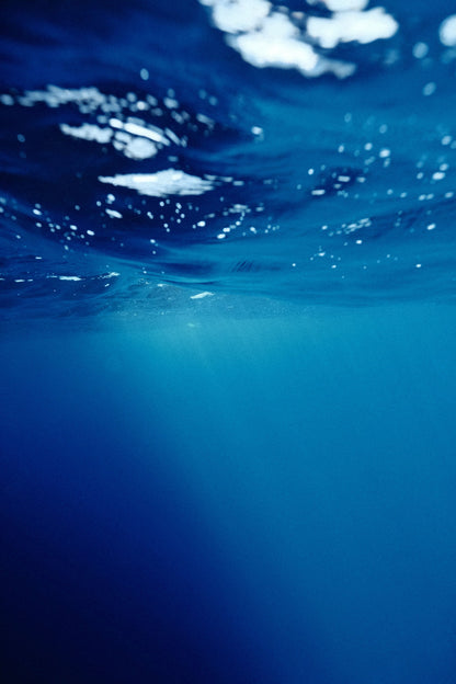 Deep blue underwater light filtering down through clear water