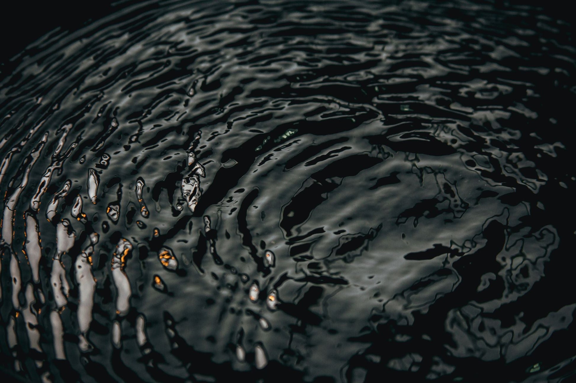 Ripples crossing dark water in low golden light, Aman Spa at The Connaught