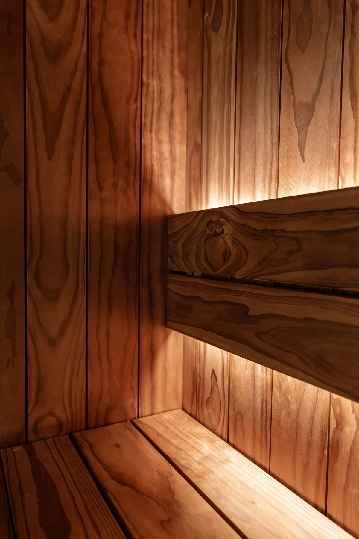 Warm light across wooden sauna panelling
