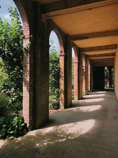 A sunlit brick arcaded corridor evoking the Regency orangery that houses the spa