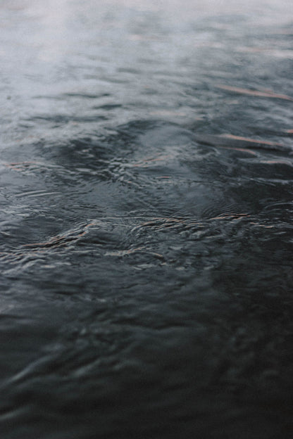 Dark water ripples across a cold plunge.