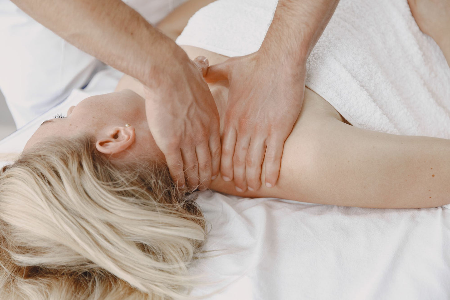 Slow work through the neck and shoulders on a treatment table, the resident osteopathy and physiotherapy at The Bvlgari Spa, Knightsbridge