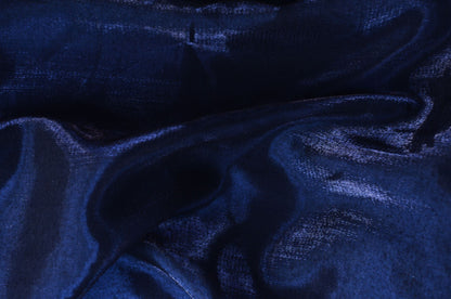Deep midnight blue fabric caught in a low raking light, the feeling of the blue upholstered walls at Asaya at The Chancery Rosewood