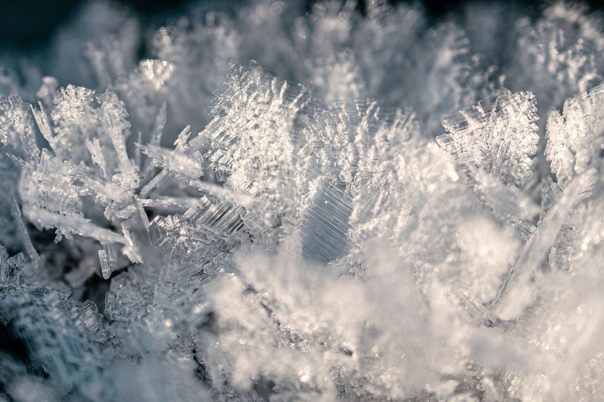 Close up of soft white frost crystals, evoking the snow shower that finishes the heat journey at the Dior Spa Cheval Blanc Paris