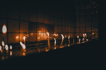 A line of candle flames reflected along a dark surface, Aquarias Spa at Whatley Manor