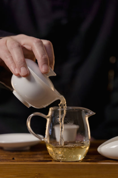 Tea poured from a white gaiwan in low light, Aman Spa at The Connaught