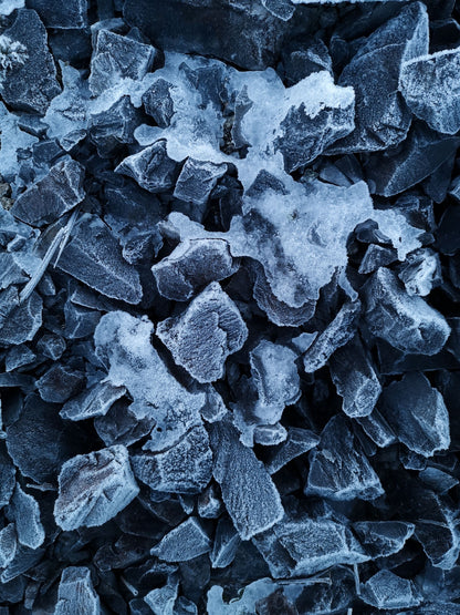 Close-up of frost-covered dark stone