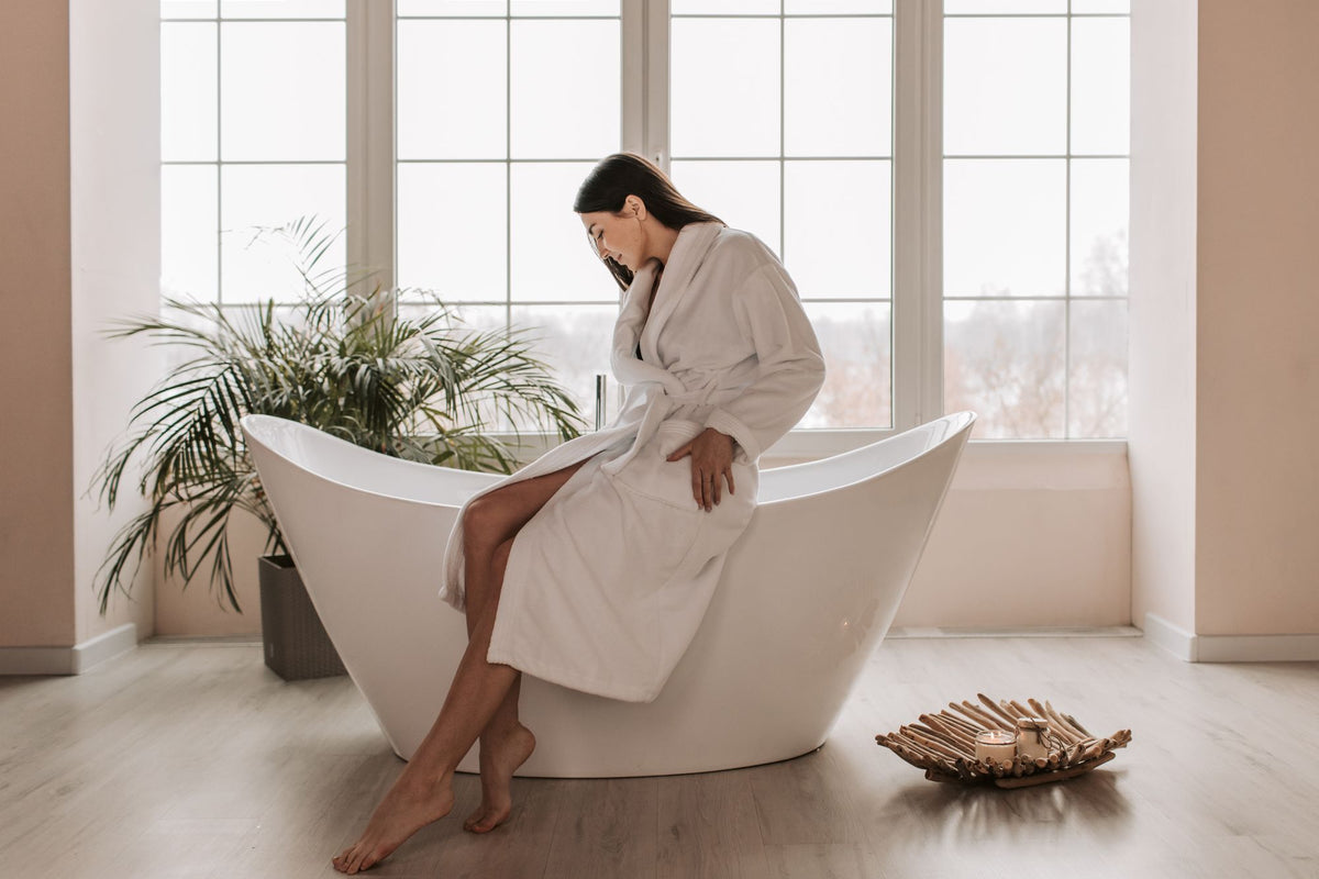 A guest in a robe, unhurried, in the pause between thermal rooms.