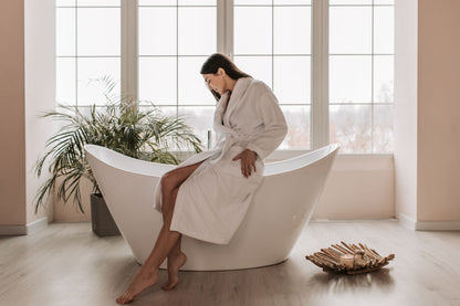 A guest in a robe, unhurried, in the pause between thermal rooms.