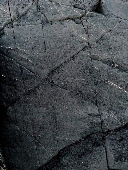 Wet slate split into dark angular planes, C-Side Spa at Cowley Manor, Cheltenham