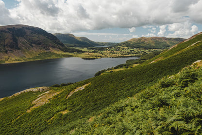 Green Lakeland fells fold around a still tarn, the landscape above Gilpin rather than the hotel itself.