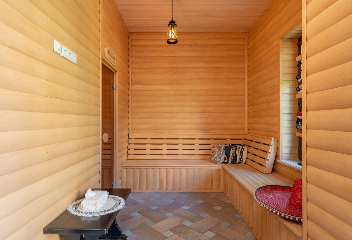 An empty wooden sauna interior, evoking the heat side of the spa