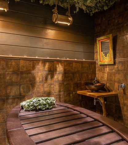 Dark wood sauna interior lit by warm low light