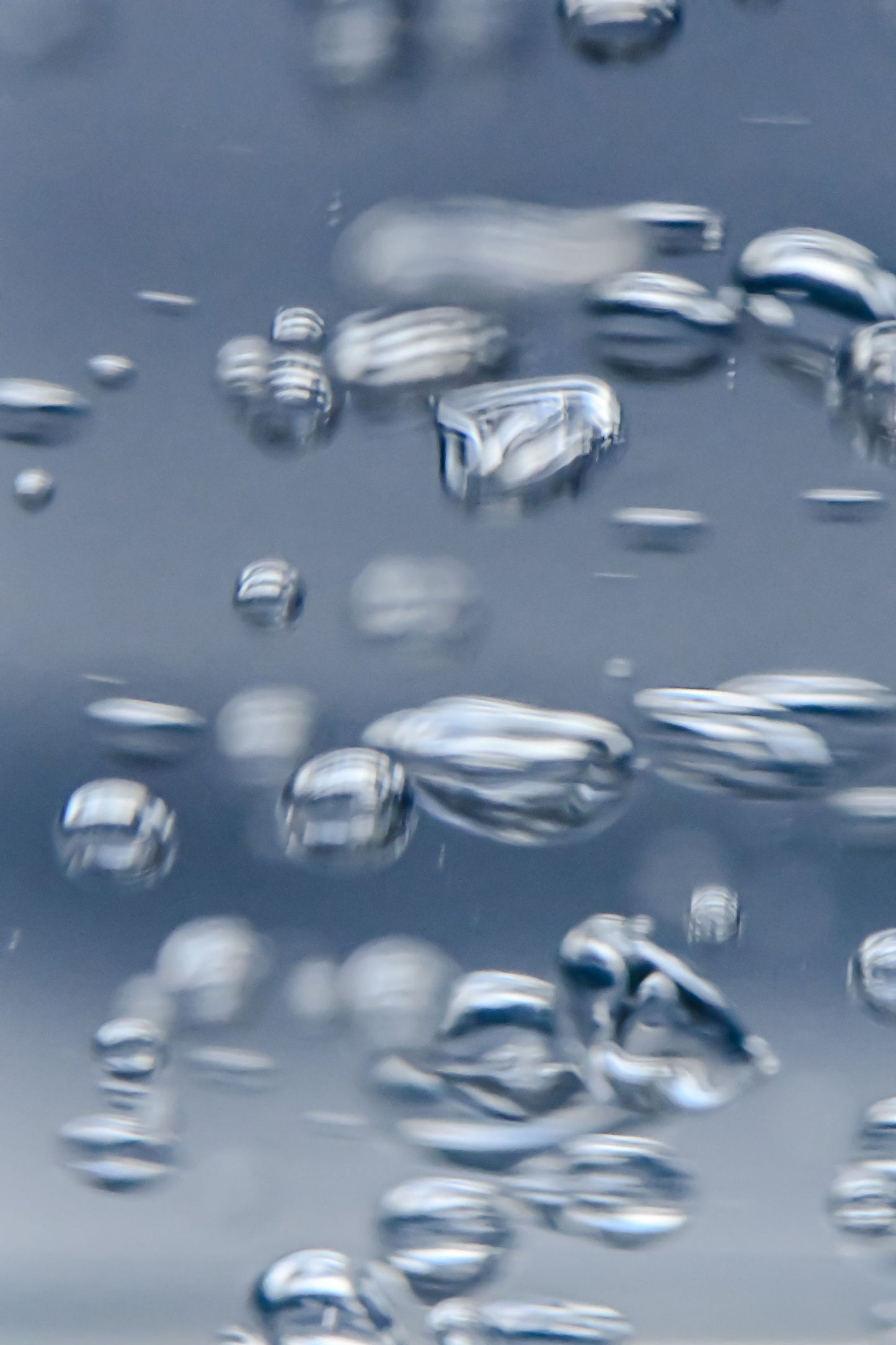 Fine bubbles rising through clear water, standing for the therapeutic jets in the skylit vitality pools