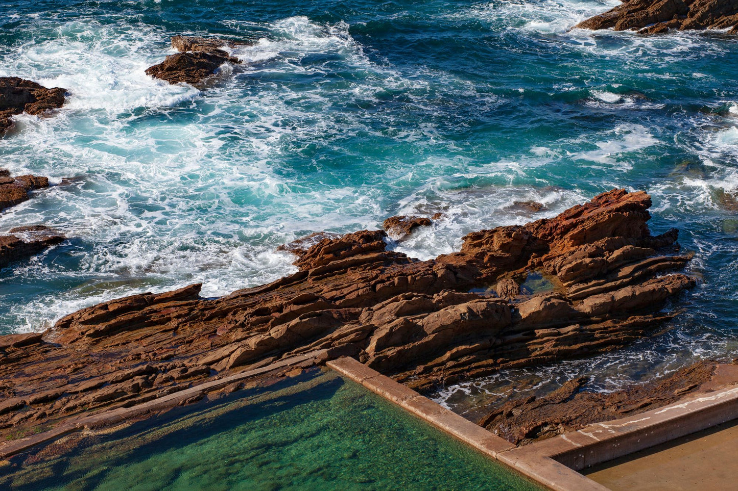 A natural seawater pool cut into coastal rocks