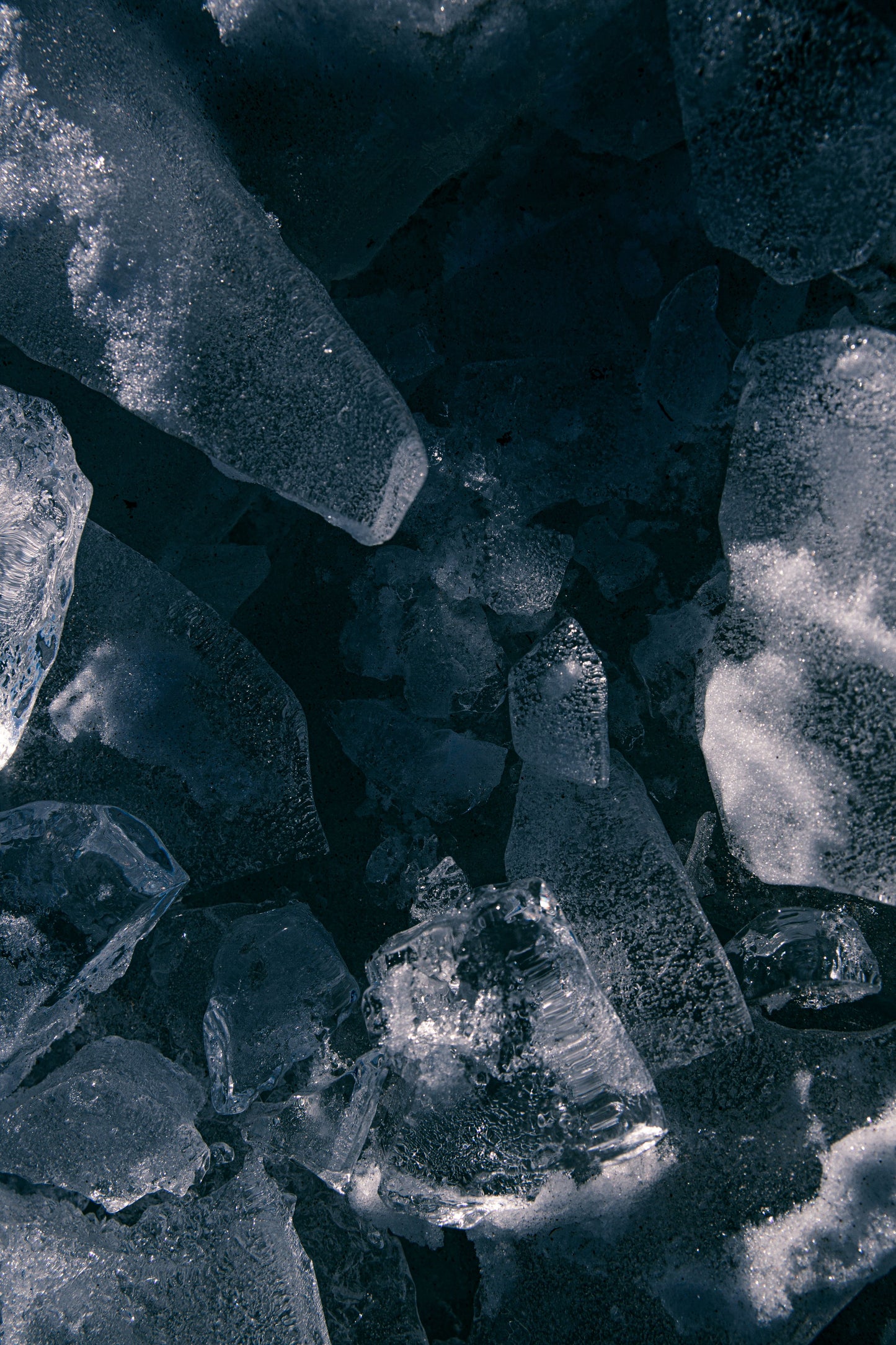 Broken slabs of ice floating on dark cold water, Eynsham Baths at Estelle Manor