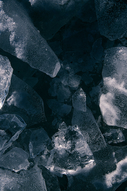 Broken slabs of ice floating on dark cold water, Eynsham Baths at Estelle Manor