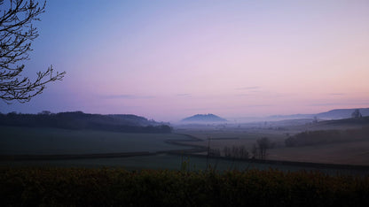 Mist settling over the countryside at dawn