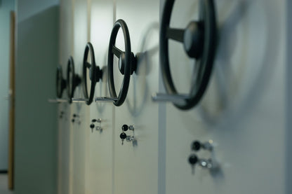 A row of old bank vault dial wheels, evoking the former strongroom the wellness floor occupies