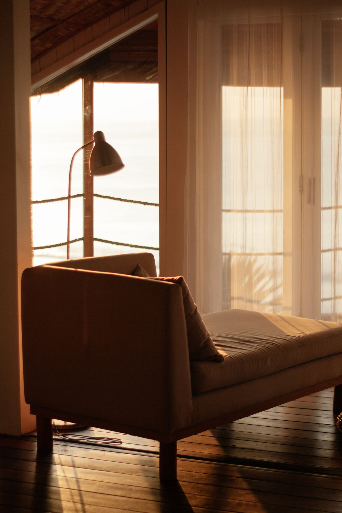 A dark, cozy armchair by a window with warm evening light, The Spa at Adare Manor, Adare