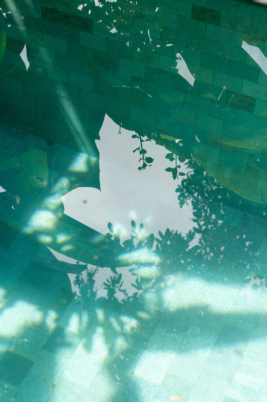 Green water seen from below with light breaking across the surface, C-Side Spa at Cowley Manor, Cheltenham