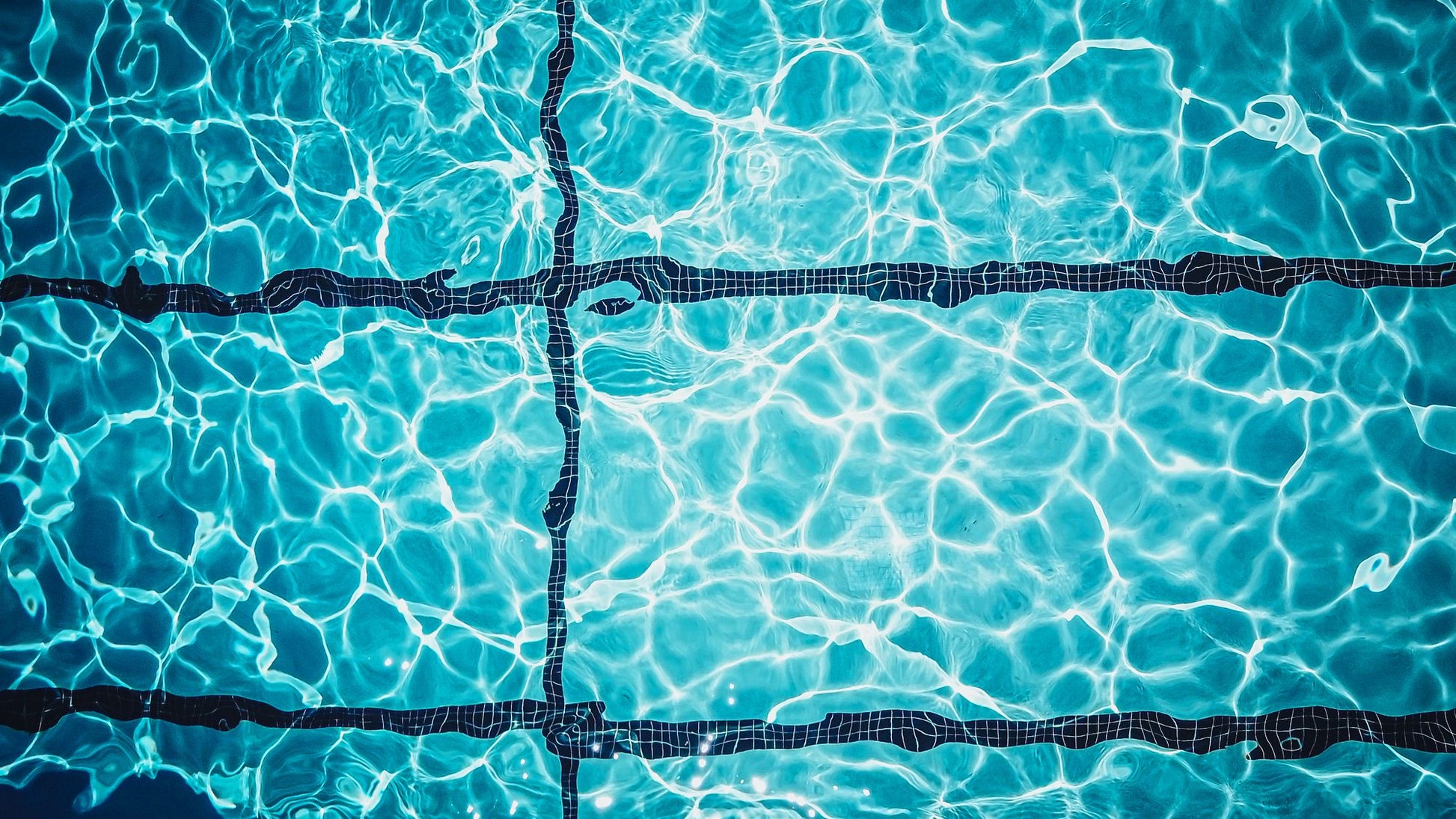 Light shifting across the tiled surface of a turquoise indoor pool, Guerlain Spa at Raffles London, The OWO