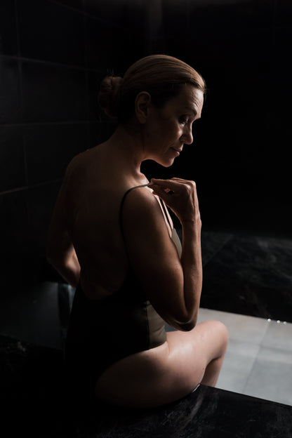 A bare shoulder and back in low warm light, Eynsham Baths at Estelle Manor