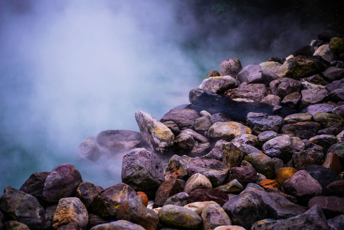 Steam rising over warm stones