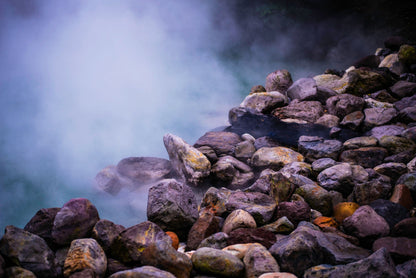 Steam rising over warm stones